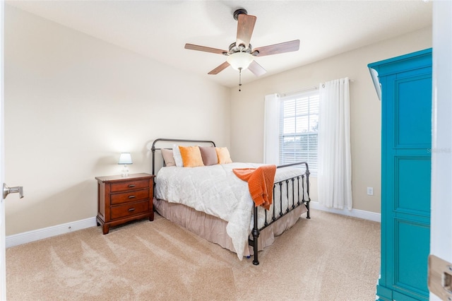 bedroom featuring light colored carpet and ceiling fan