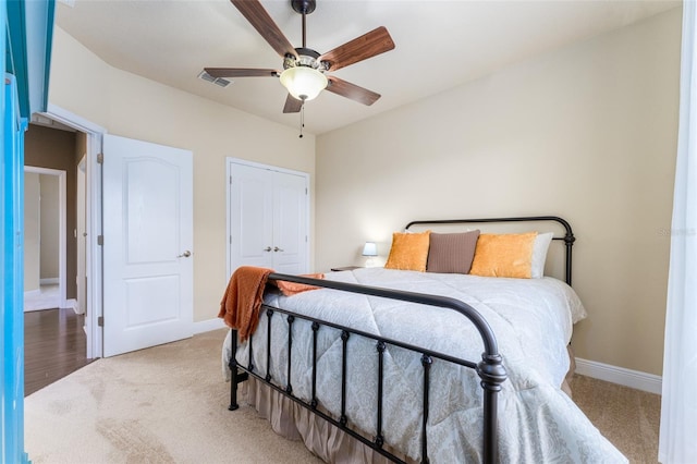 bedroom with wood-type flooring, ceiling fan, and a closet