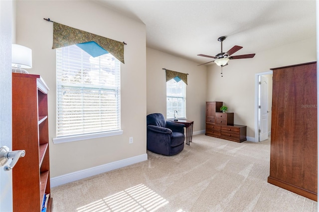 sitting room featuring ceiling fan and light colored carpet