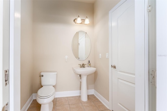 bathroom featuring tile patterned flooring, sink, and toilet