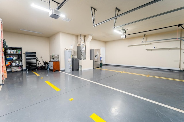 garage featuring electric water heater, heating unit, a garage door opener, and stainless steel fridge