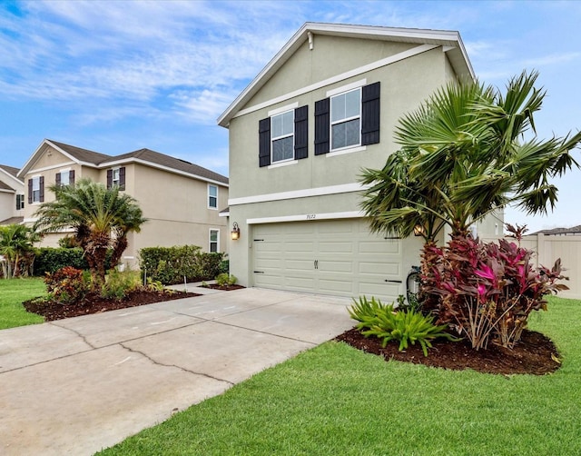 view of property featuring a garage and a front lawn