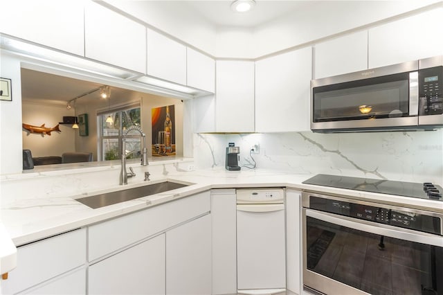 kitchen with white cabinetry, sink, and appliances with stainless steel finishes