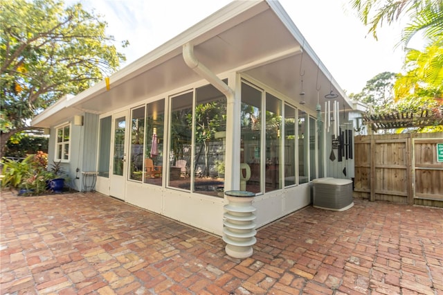 view of property exterior with a patio area