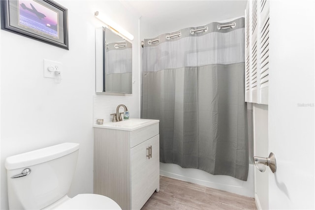 full bathroom featuring vanity, toilet, shower / tub combo, and wood-type flooring