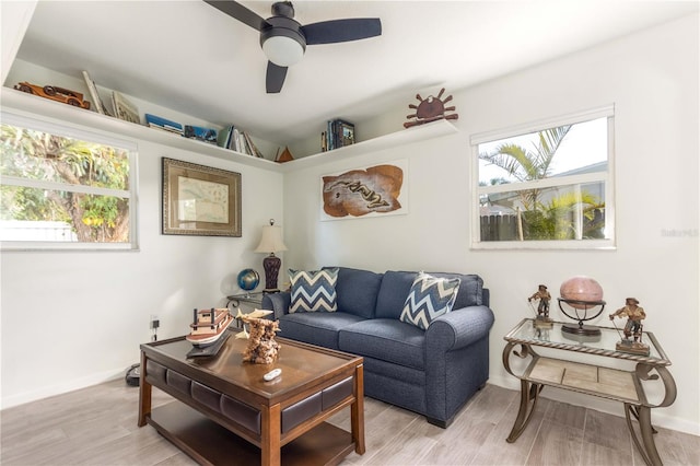 living room featuring light hardwood / wood-style floors and ceiling fan