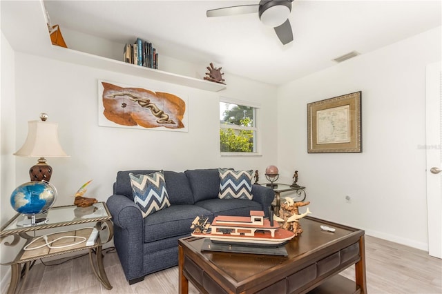 living room with ceiling fan and light wood-type flooring