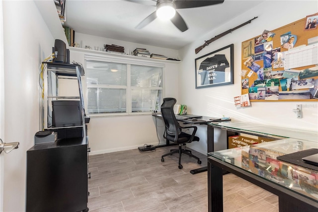 home office featuring light hardwood / wood-style floors and ceiling fan