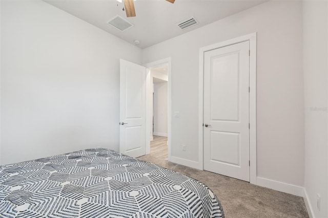 unfurnished bedroom featuring ceiling fan and light colored carpet