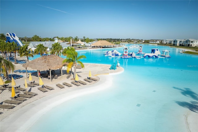 view of swimming pool with a gazebo and a water view