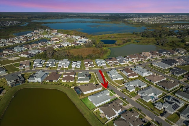 aerial view at dusk with a water view