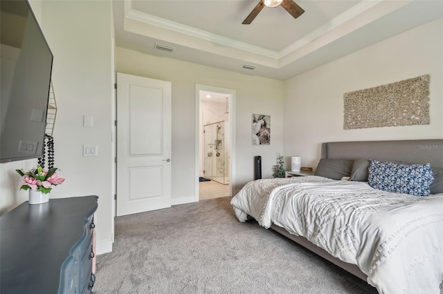 carpeted bedroom featuring connected bathroom, a raised ceiling, ceiling fan, and ornamental molding