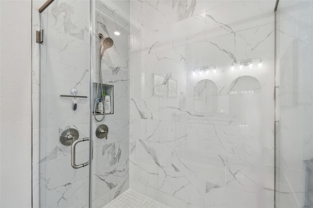 bathroom featuring a shower with door