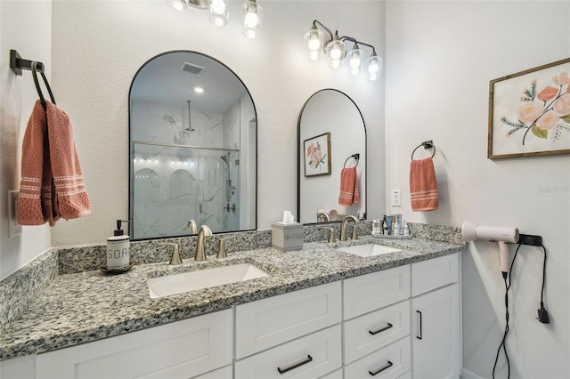 bathroom featuring vanity and an enclosed shower