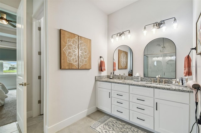 bathroom with a shower, vanity, and ceiling fan