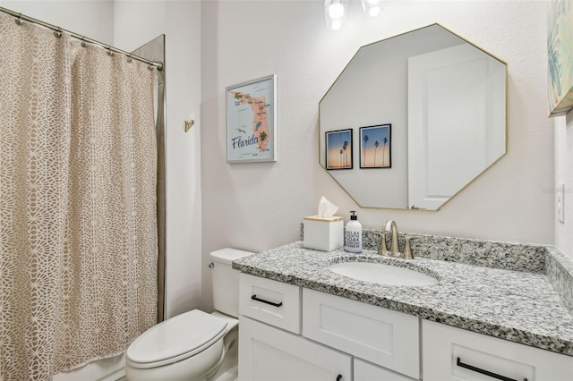 bathroom featuring a shower with shower curtain, vanity, and toilet