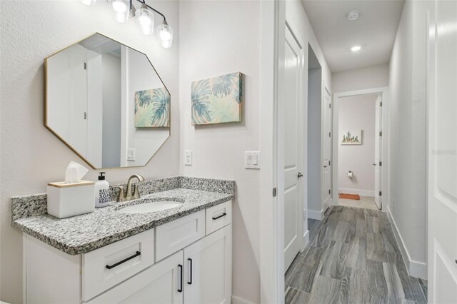 bathroom with vanity and hardwood / wood-style flooring