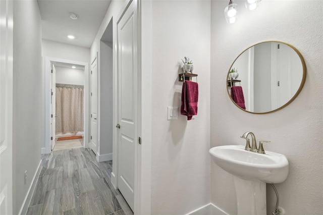 bathroom with hardwood / wood-style flooring