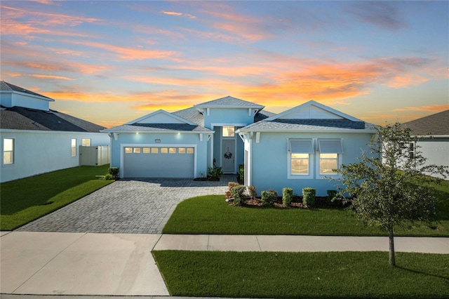 view of front of home featuring a lawn and a garage