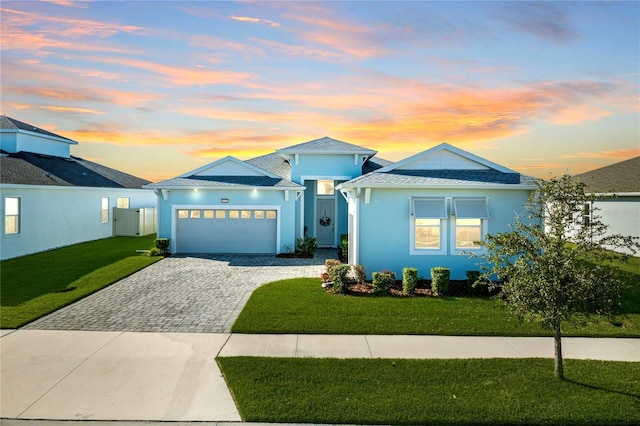 view of front of house with a yard and a garage