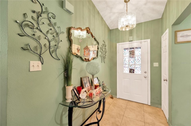 entryway featuring a notable chandelier, a textured ceiling, and light tile patterned floors