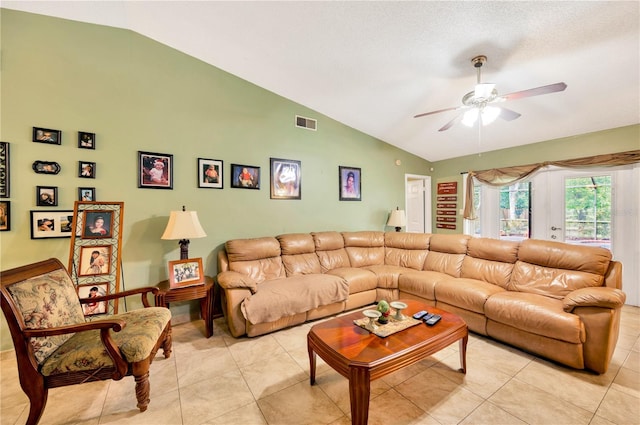 living room featuring ceiling fan, light tile patterned flooring, and lofted ceiling