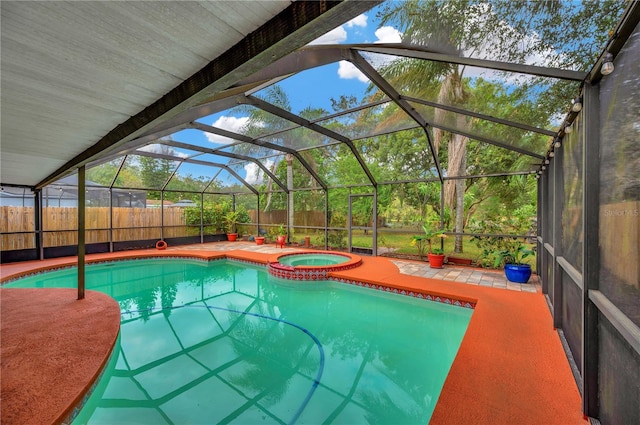 view of swimming pool featuring an in ground hot tub, a patio, and a lanai