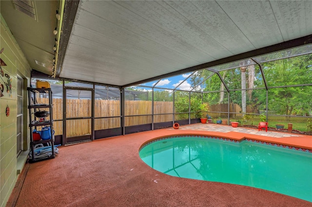 view of pool with a patio area and a lanai