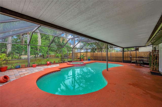 view of swimming pool featuring an in ground hot tub, a patio area, and glass enclosure