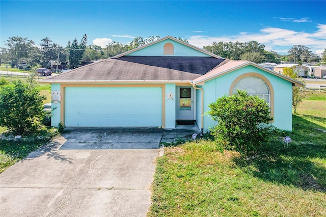 single story home with a front yard and a garage