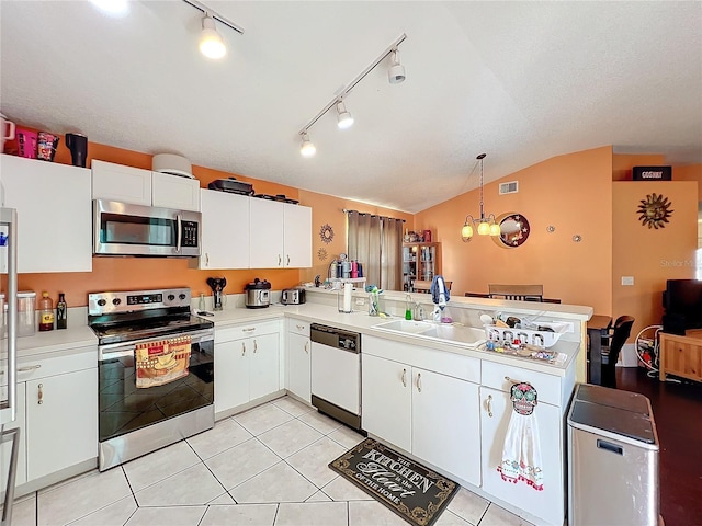 kitchen featuring decorative light fixtures, kitchen peninsula, stainless steel appliances, and white cabinetry