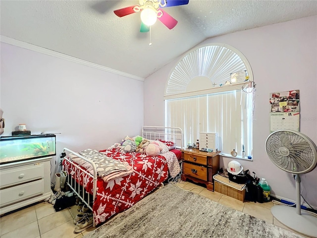 bedroom featuring ceiling fan, light tile patterned flooring, a textured ceiling, and lofted ceiling