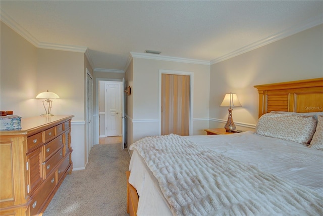 carpeted bedroom featuring crown molding and a closet