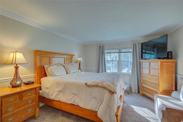 carpeted bedroom featuring crown molding and a textured ceiling