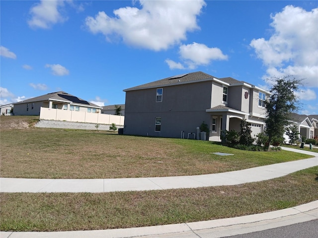 view of side of home with a yard