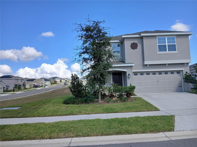 view of property with a front yard and a garage