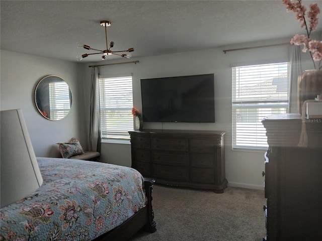 bedroom with a textured ceiling, carpet floors, and an inviting chandelier