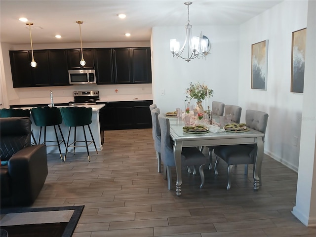 dining area featuring hardwood / wood-style floors and a chandelier