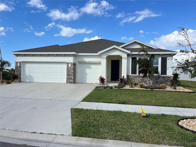 view of front facade featuring a front yard and a garage