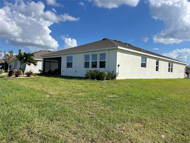 back of property featuring a lawn