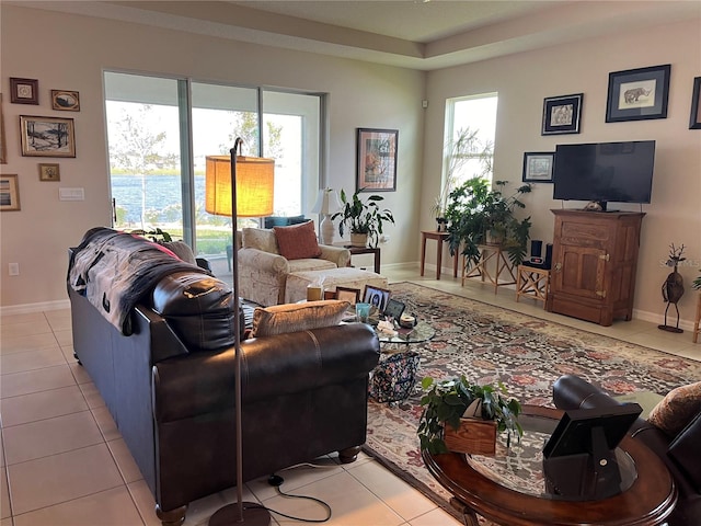 living room with a wealth of natural light and light tile patterned floors