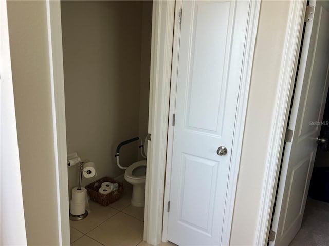 bathroom featuring toilet and tile patterned flooring