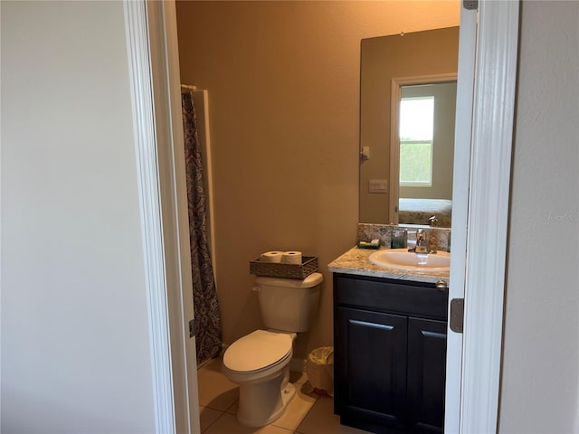 bathroom featuring vanity, toilet, tile patterned floors, and curtained shower