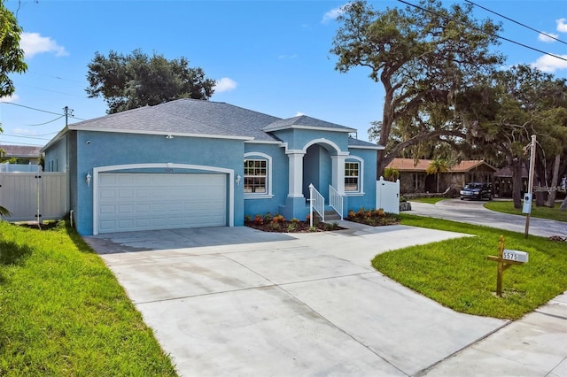 ranch-style house with a front yard and a garage