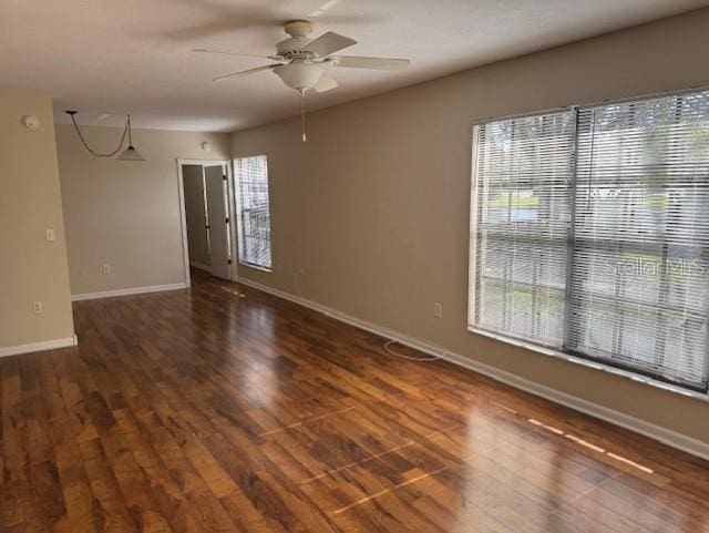 spare room featuring dark hardwood / wood-style floors and ceiling fan