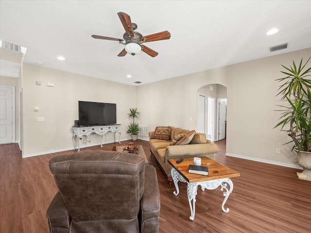 living room with dark wood-type flooring and ceiling fan