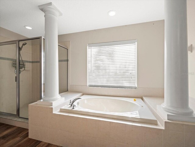 bathroom with hardwood / wood-style floors and shower with separate bathtub