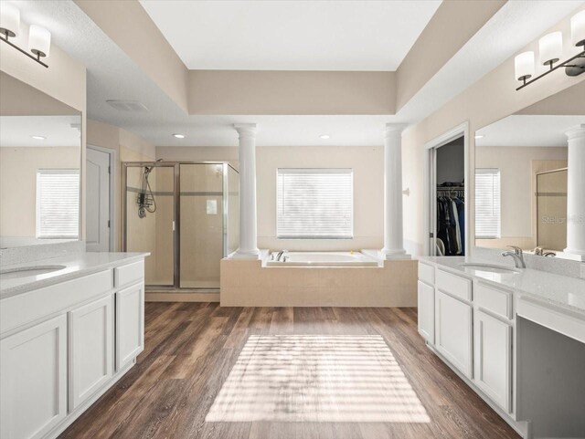 bathroom featuring vanity, hardwood / wood-style flooring, and separate shower and tub