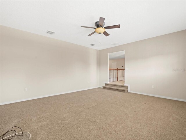 empty room with carpet floors and ceiling fan