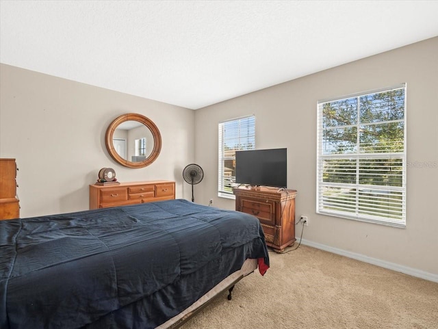 bedroom featuring light colored carpet